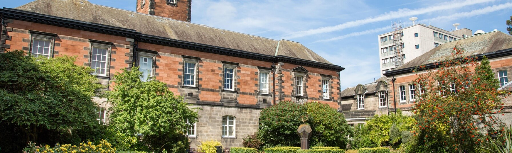 Dundee University with sky background and trees
