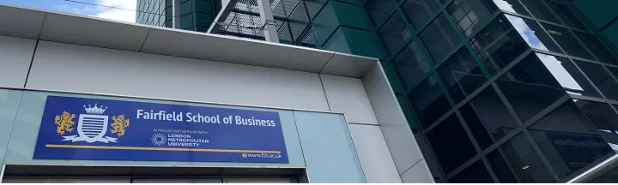 Fairfield School of Business with logo and tall building 