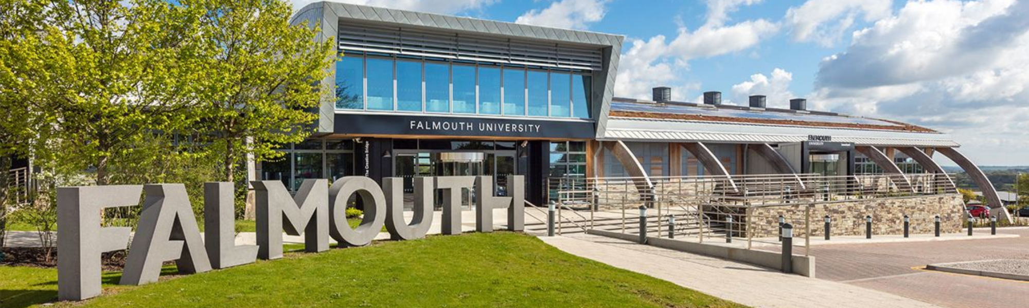 Falmouth University with 'Falmouth' sign ,  and the sky in the background 