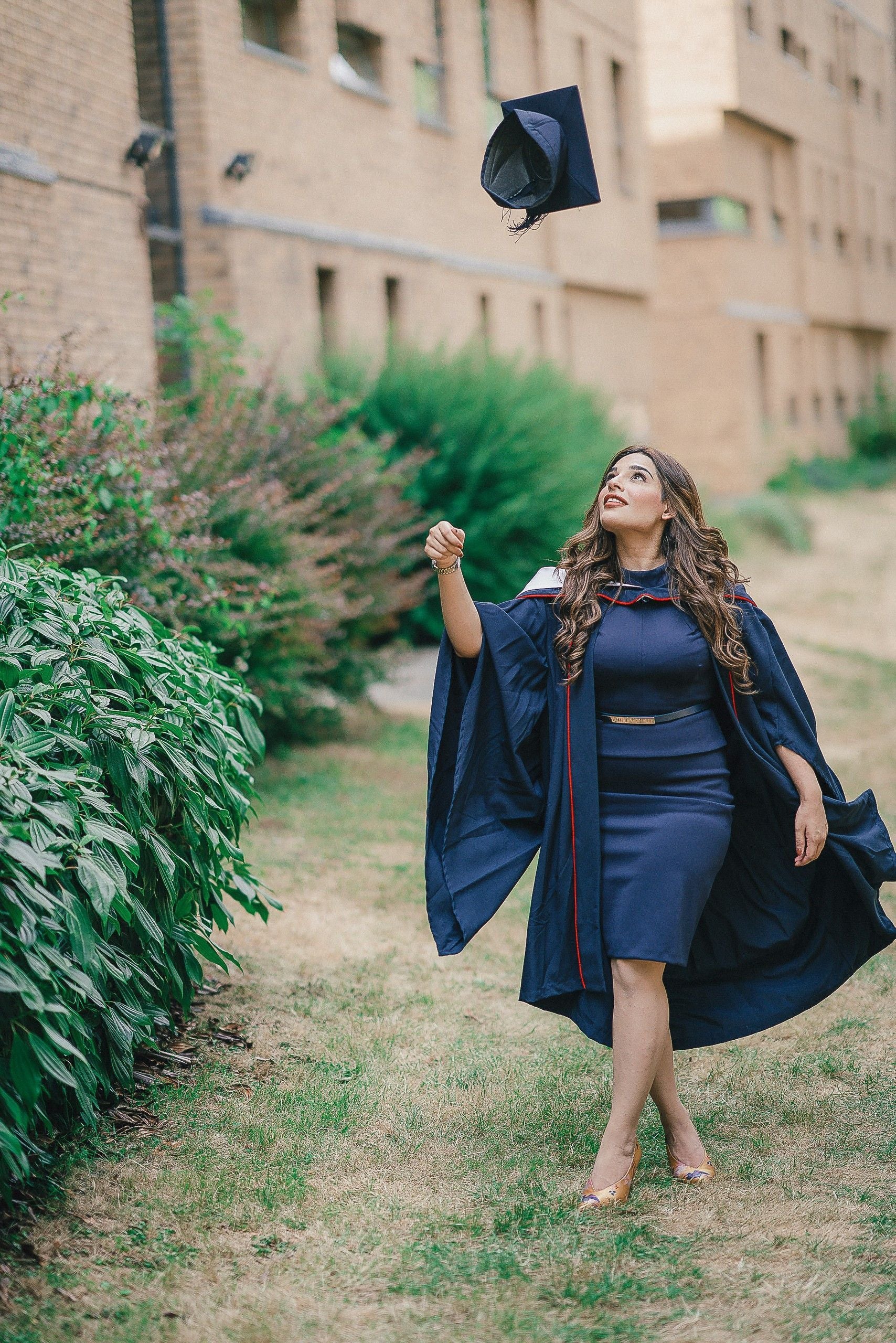 University graduate throwing their caps in the air 