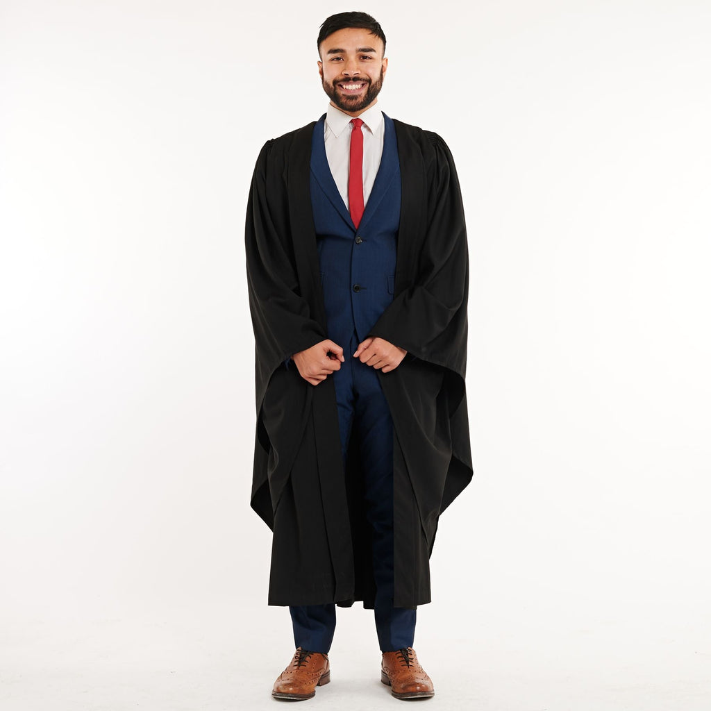 Happy African Student In Black Graduation Gown And Cap Raises Masters  Degree Diploma Above Head On White Background. Graduate African Man Is  Graduating College And Celebrating Academic Achievement Stock Photo,  Picture and
